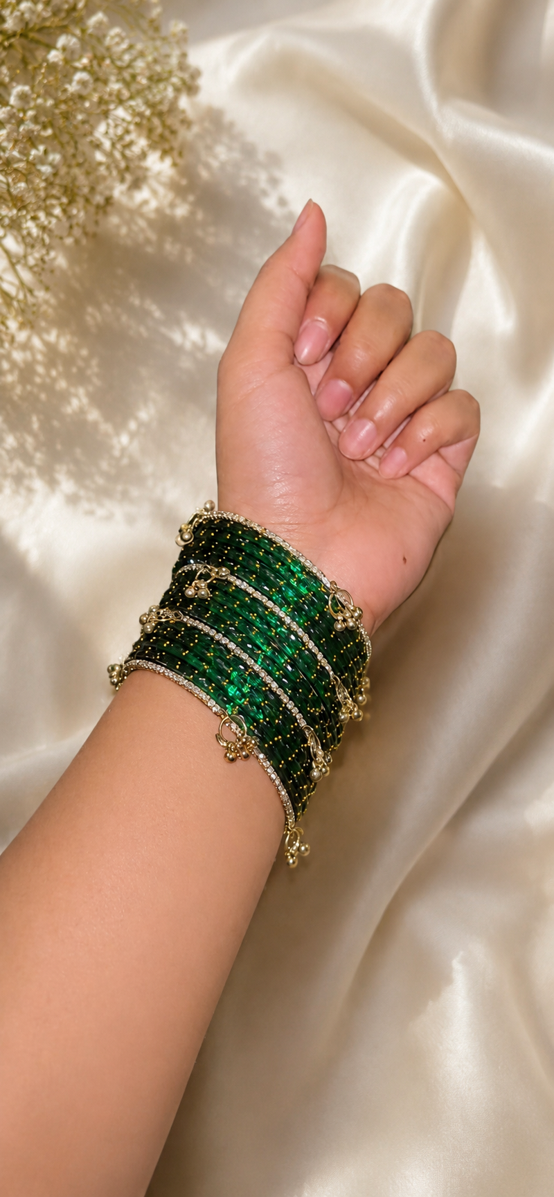 Glass bangles sitting on a wrist with a little room, not tight